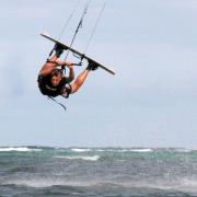 Kiteboarder Mads jumps "unhooked railey" at Bulabog Beach.