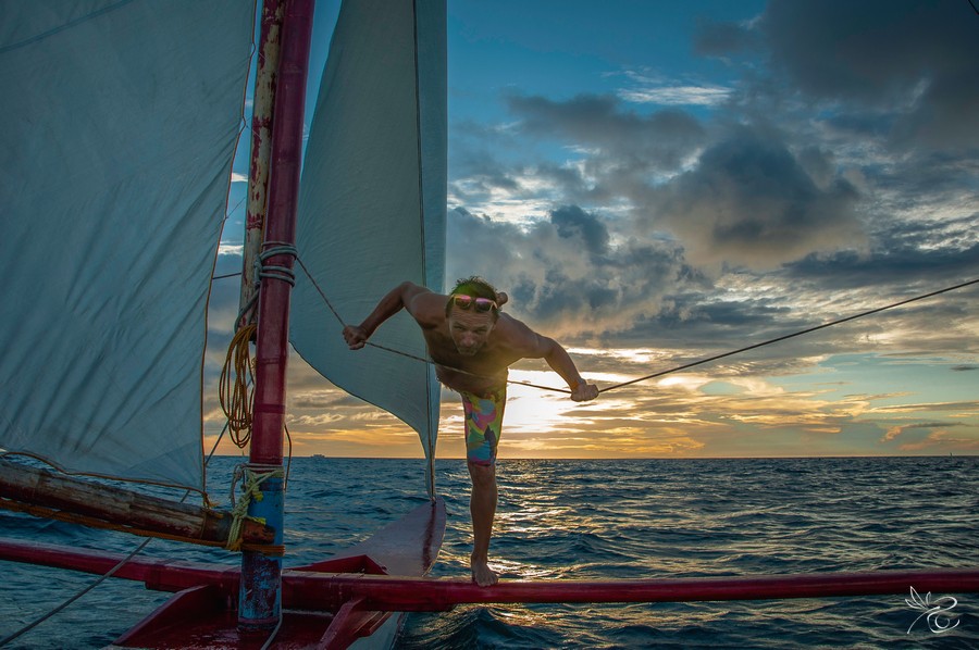 Kite Instructor Alex ifrom FBC Boracay is balancing on the sailing boat after yoga classes